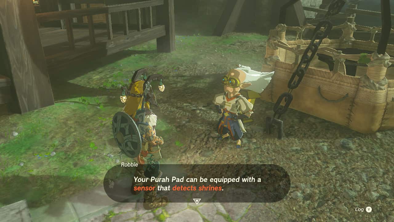 Tears of the Kingdom Shrine Sensor: Link talking to Robbie next to a hot air balloon. The text reads: "Your Purah Pad can be equipped with a sensor that detects shrines."
