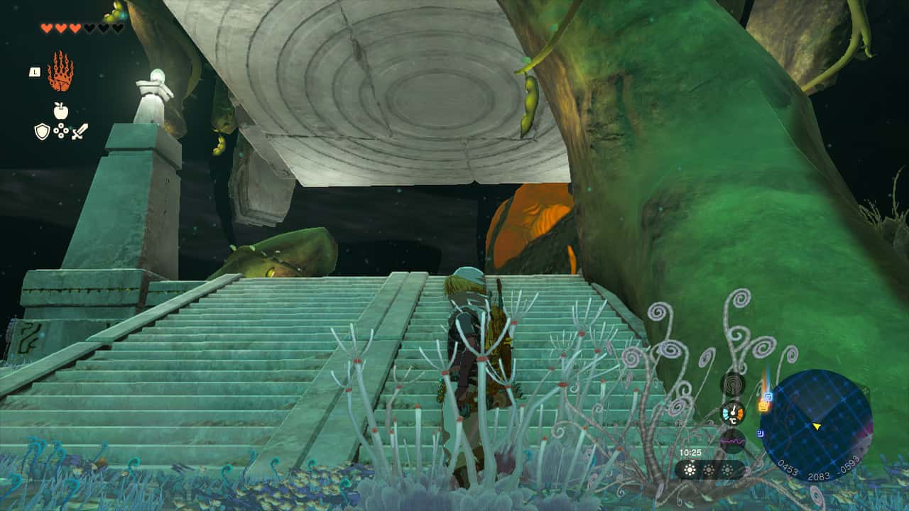 Tears of the Kingdom Lost Woods: Link standing next to some stone stairs and a tree root with a large stone pillar hanging from the ceiling.