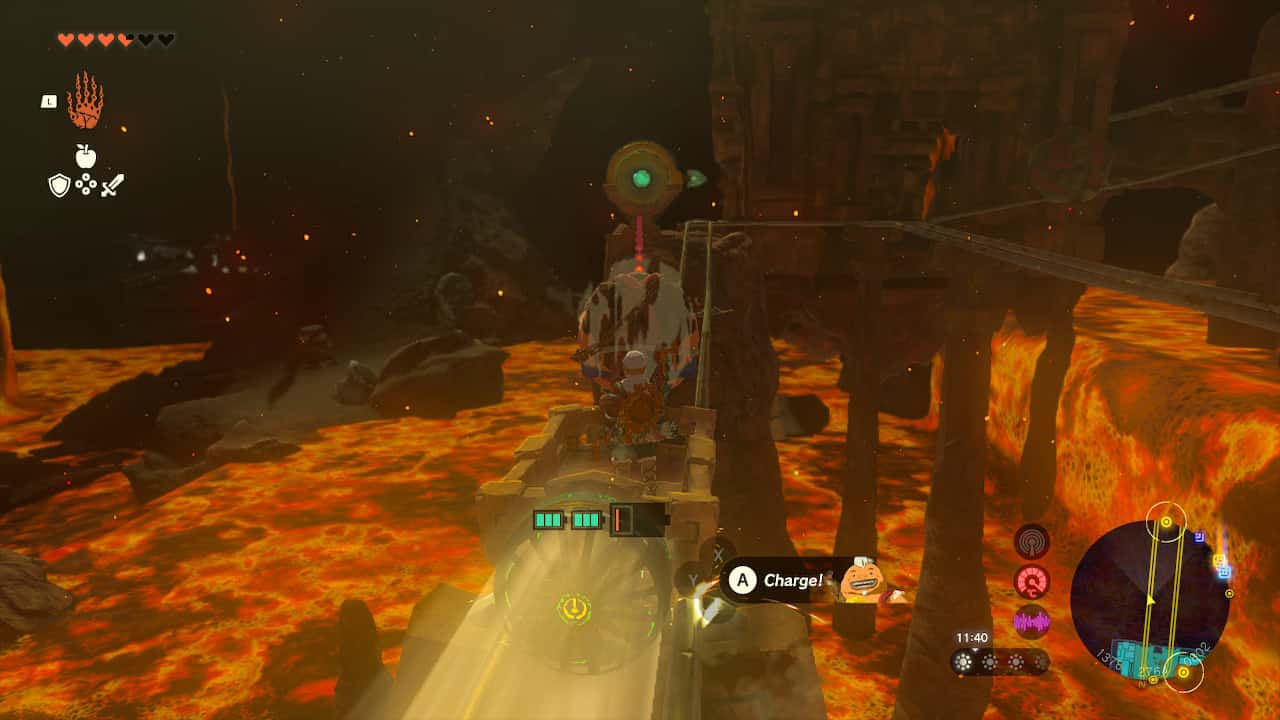 Tears of the Kingdom Fire Temple: Link riding a minecart. Yunobo aims at a switch in the distance.