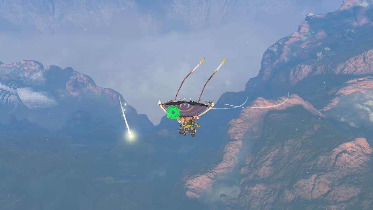 Tears of the Kingdom dragon claws: Link gliding above a Dragon Claw falling below him with a shining trail.