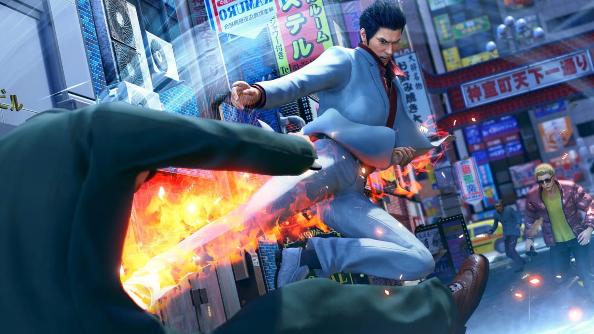 A man in a light gray suit performs a powerful flaming kick against an opponent in a bustling city street in Yakuza Kiwami 3