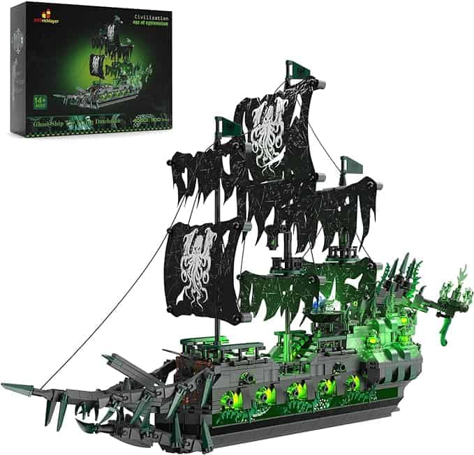 A pirate ship with green lights and a box glowing in the darkness.