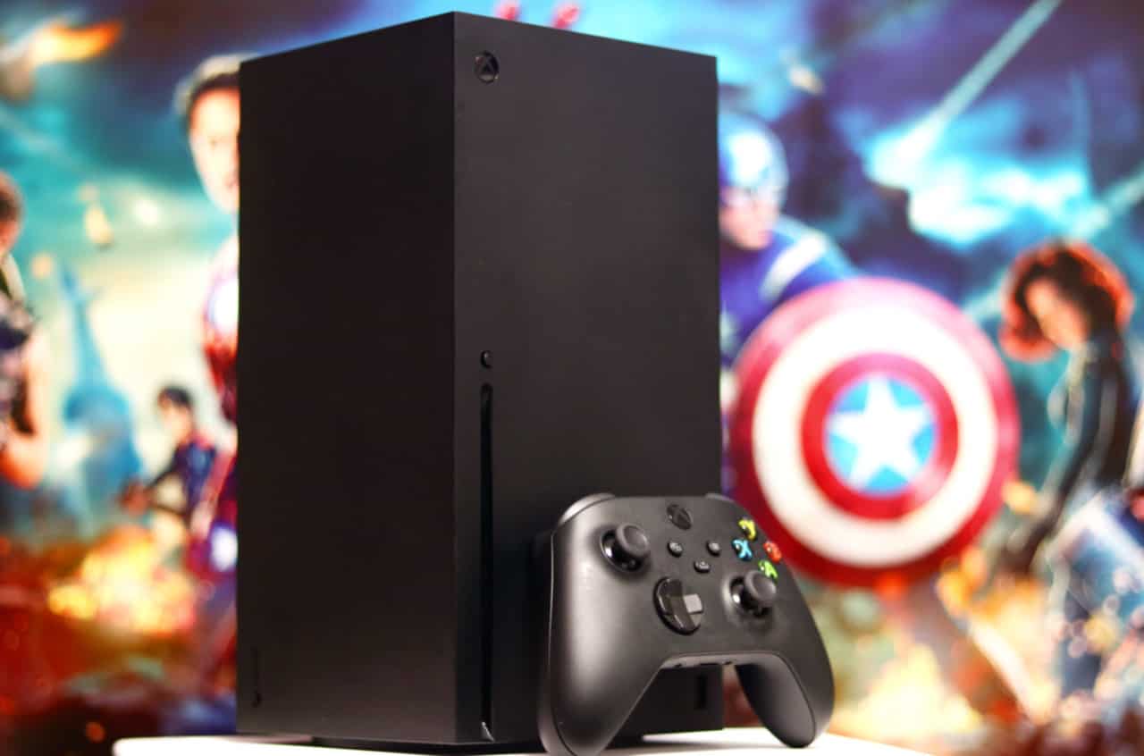 A black Xbox sat on a table next to a Captain America game in 2024.