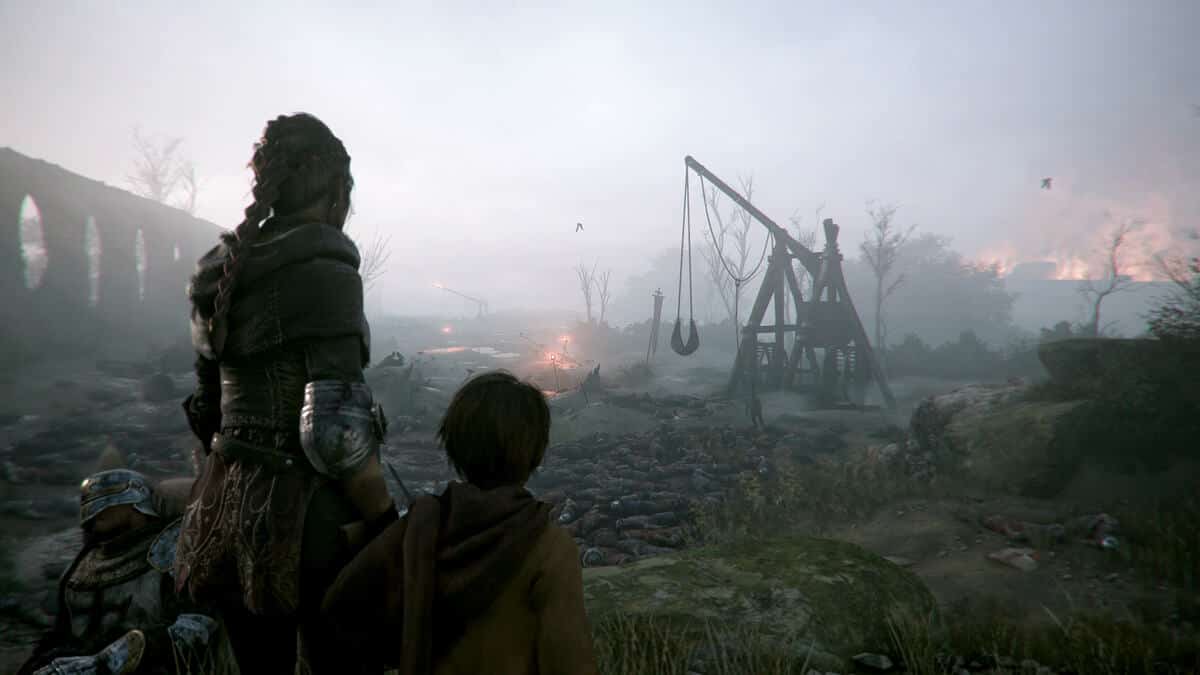 Two people stand overlooking a desolate battlefield in A Plague Tale: Innocence.
