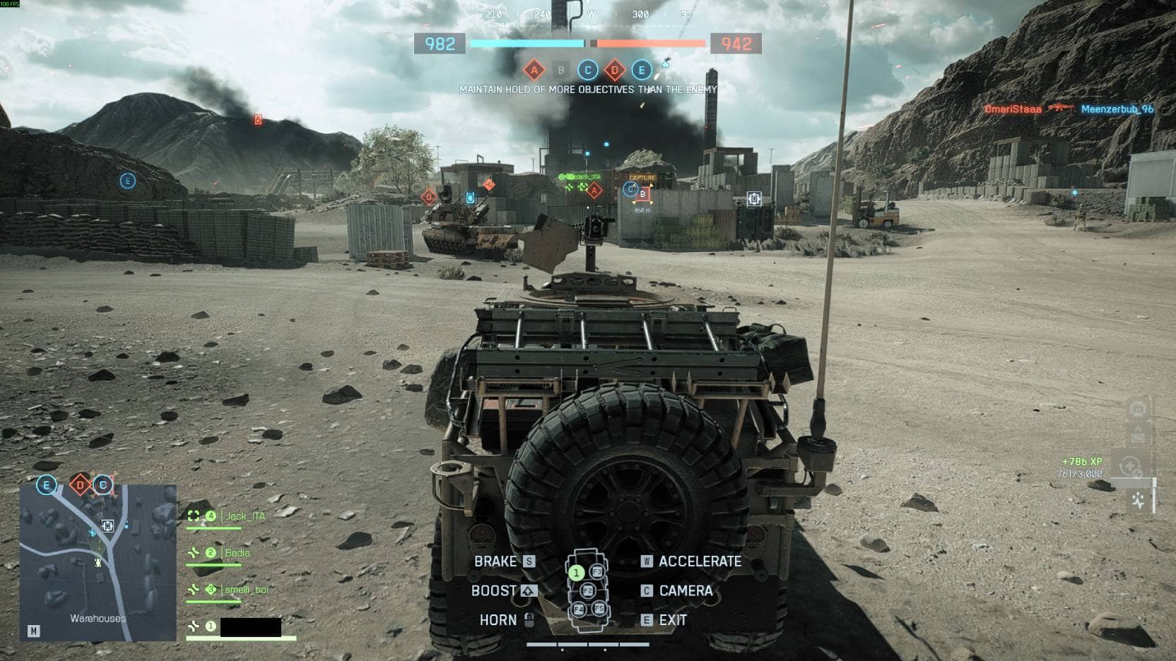 Player drives a light armored vehicle toward contested objectives on a desert map in Battlefield 6
