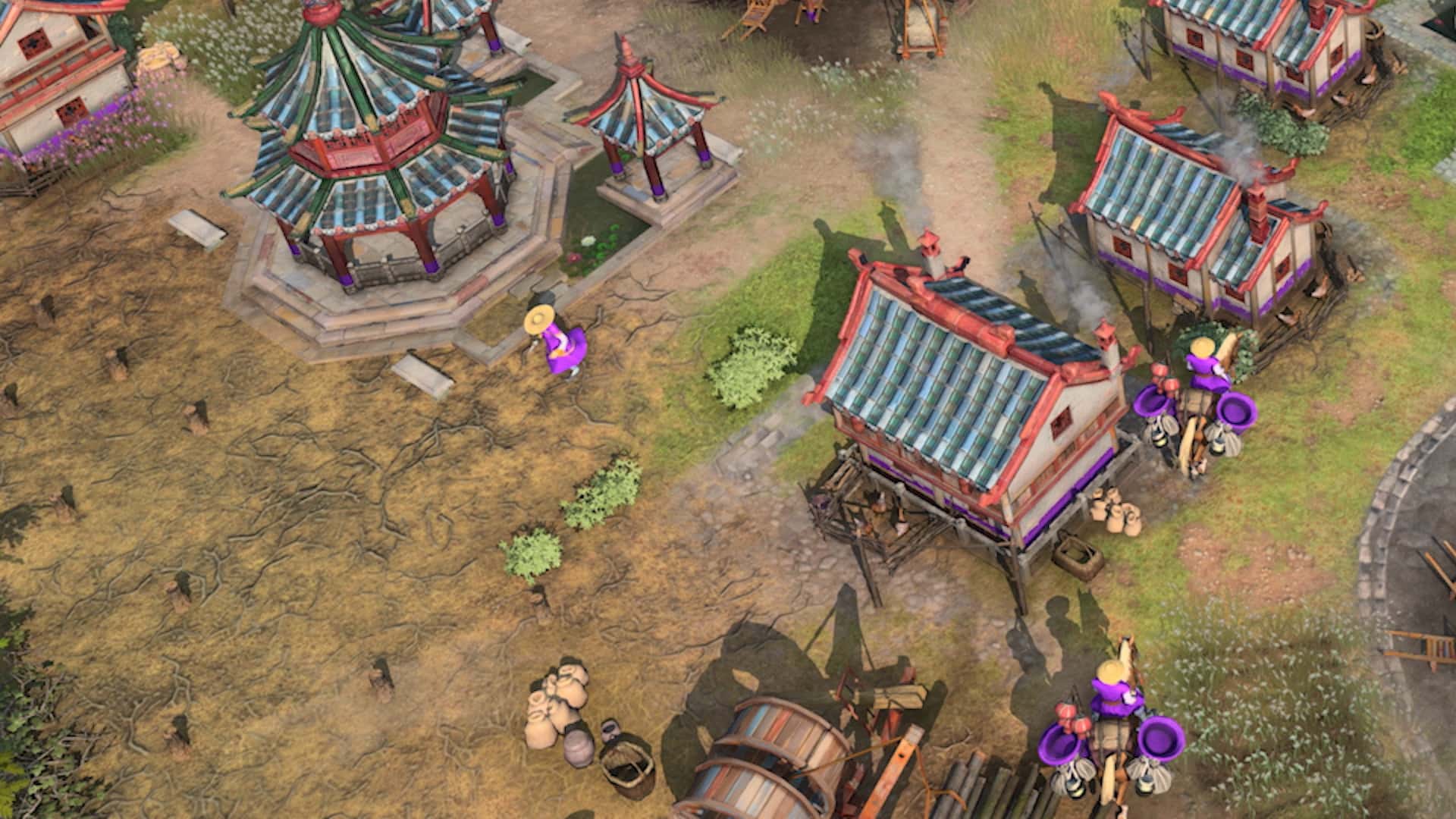 Aerial view of a vibrant, medieval Asian village with ornate, colorful buildings in Age of Empires IV