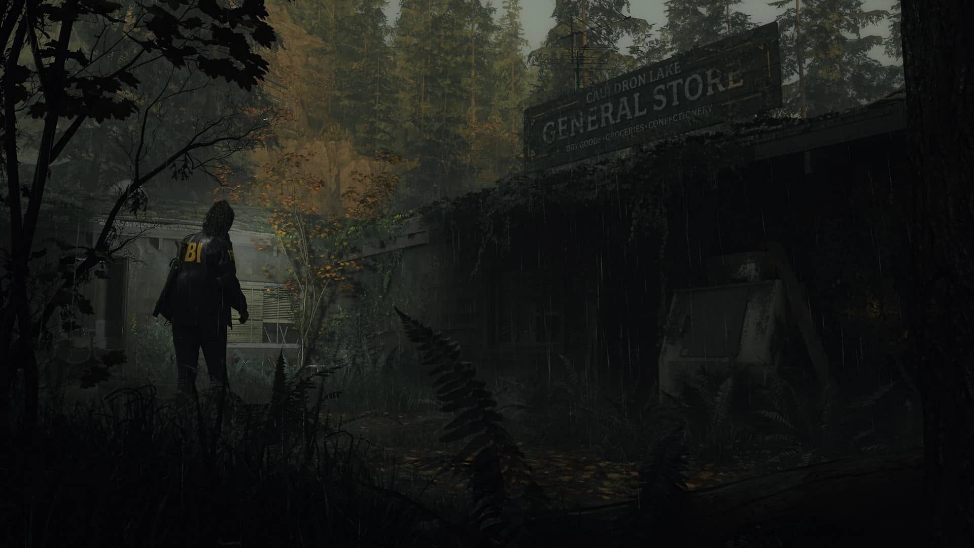Saga Anderson stands in the rain outside the overgrown Cauldron Lake General Store in Alan Wake 2, surrounded by dense forest and eerie twilight.