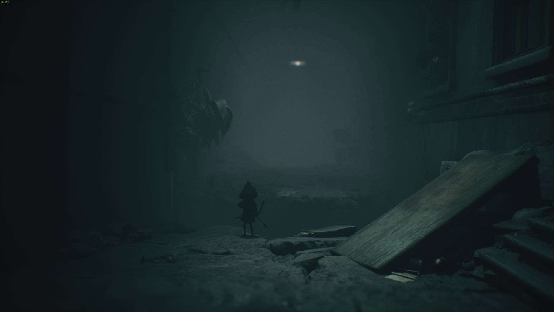 The player character stands at the edge of a crumbling hallway in All Little Nightmares 3, peering into the darkness ahead.