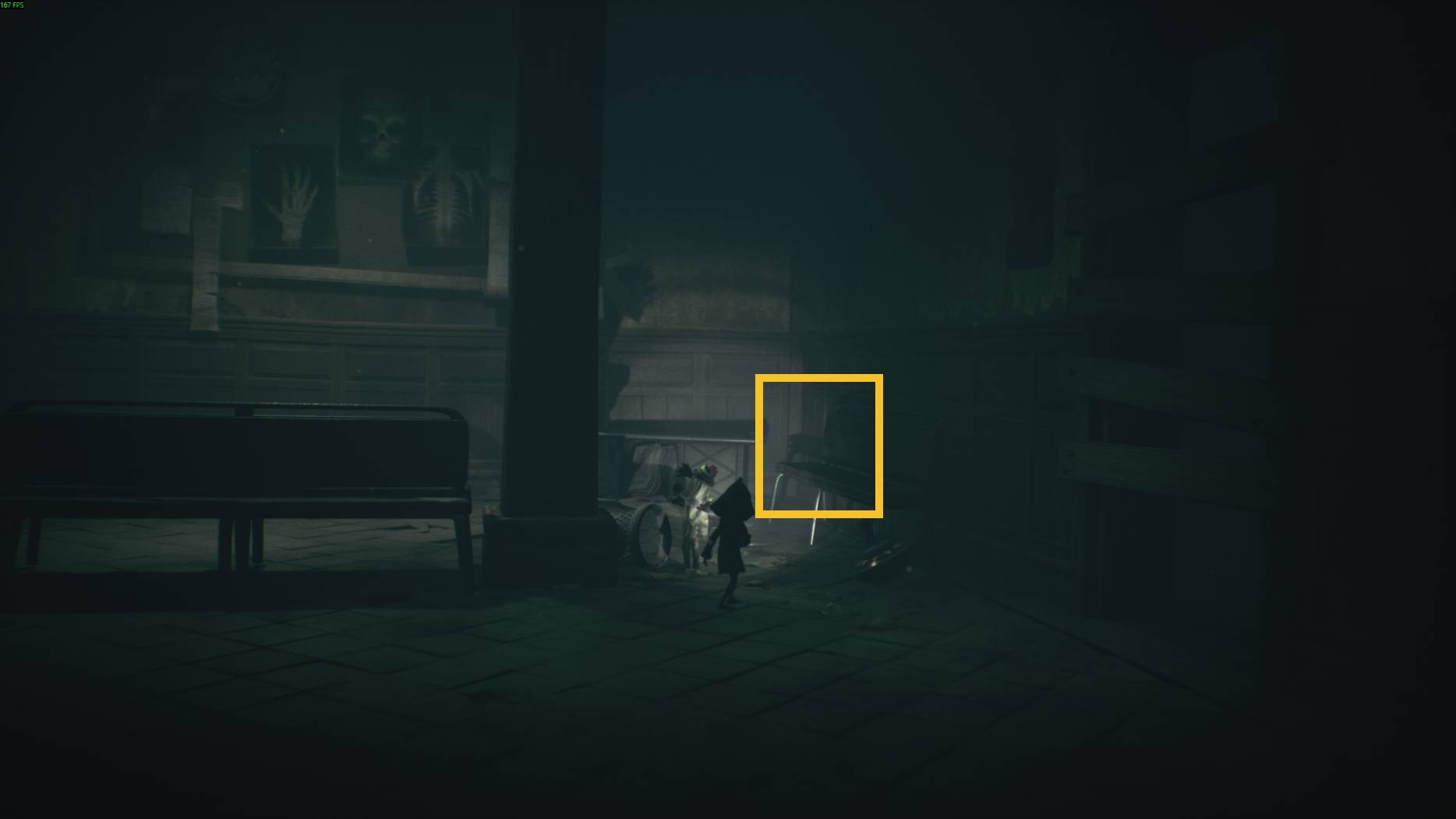 The children shine a light on a faint ghostly figure near a bench in the eerie infirmary hallway in All Little Nightmares 3.