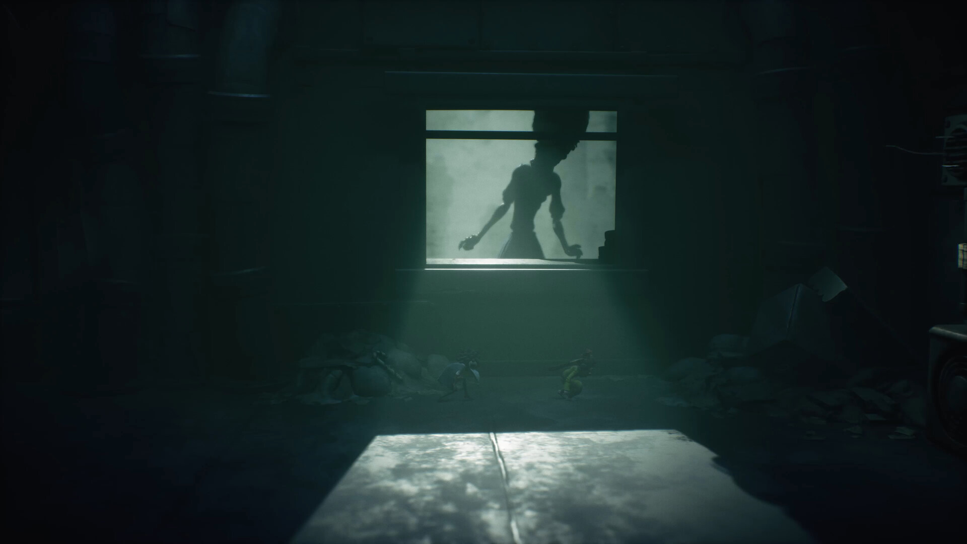 Dark, eerie room with a window showing a large, shadowy silhouette. Dim light highlights two small figures below, evoking a tense and mysterious tone