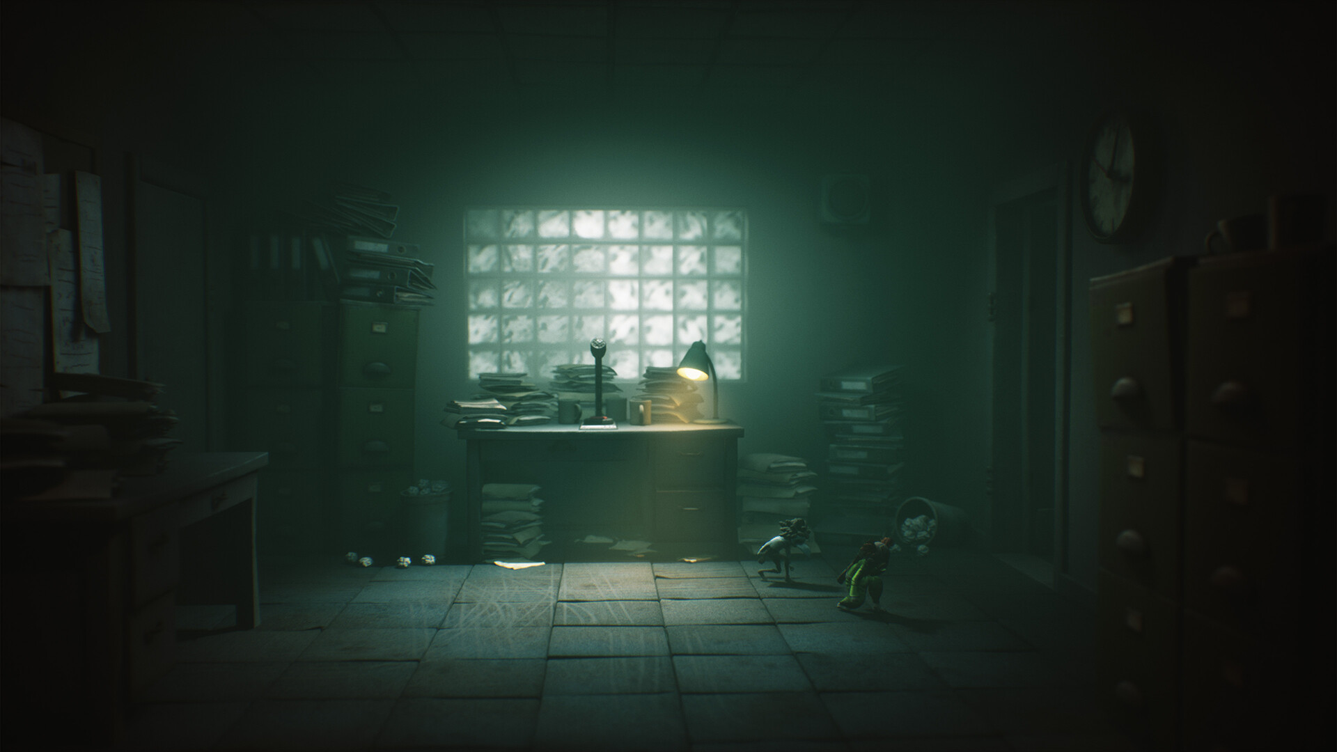 Dimly lit office with cluttered desk and stacks of papers, illuminated by a single green lamp. Two small figures sneak across the shadowy floor