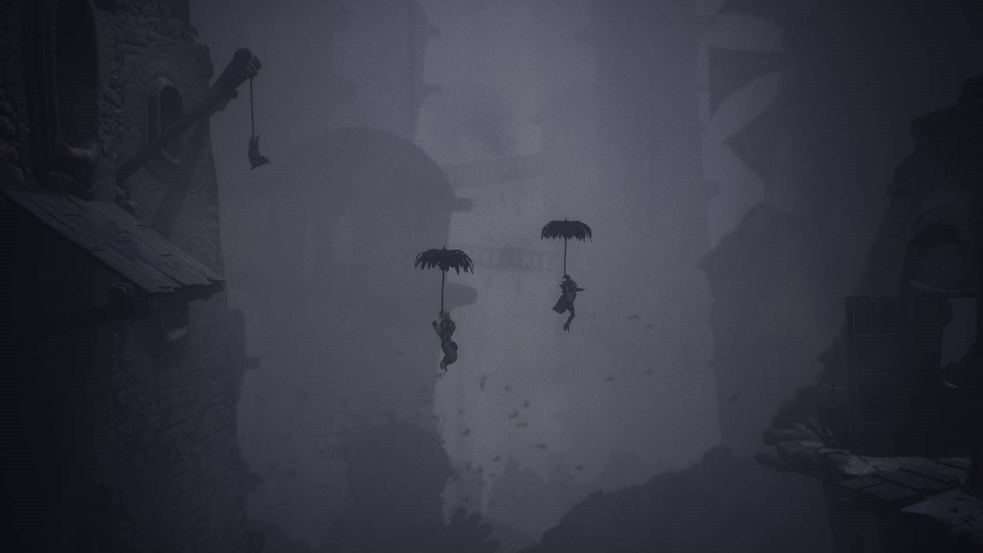 Two figures float with umbrella-like devices, surrounded by tall, dark buildings