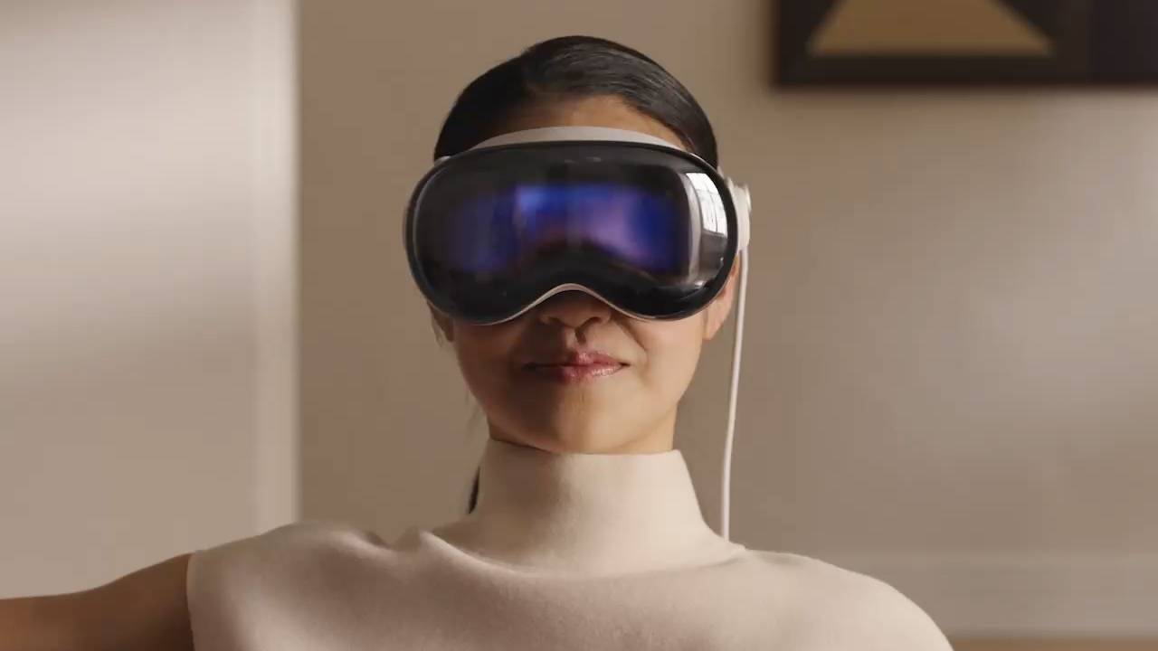 A woman wearing Apple Vision Pro headsets, experiencing virtual reality.
