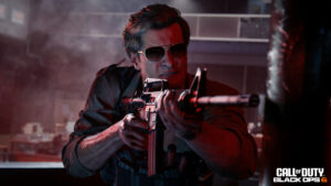 black ops 6 open beta release date window - a man with glasses holds a gun