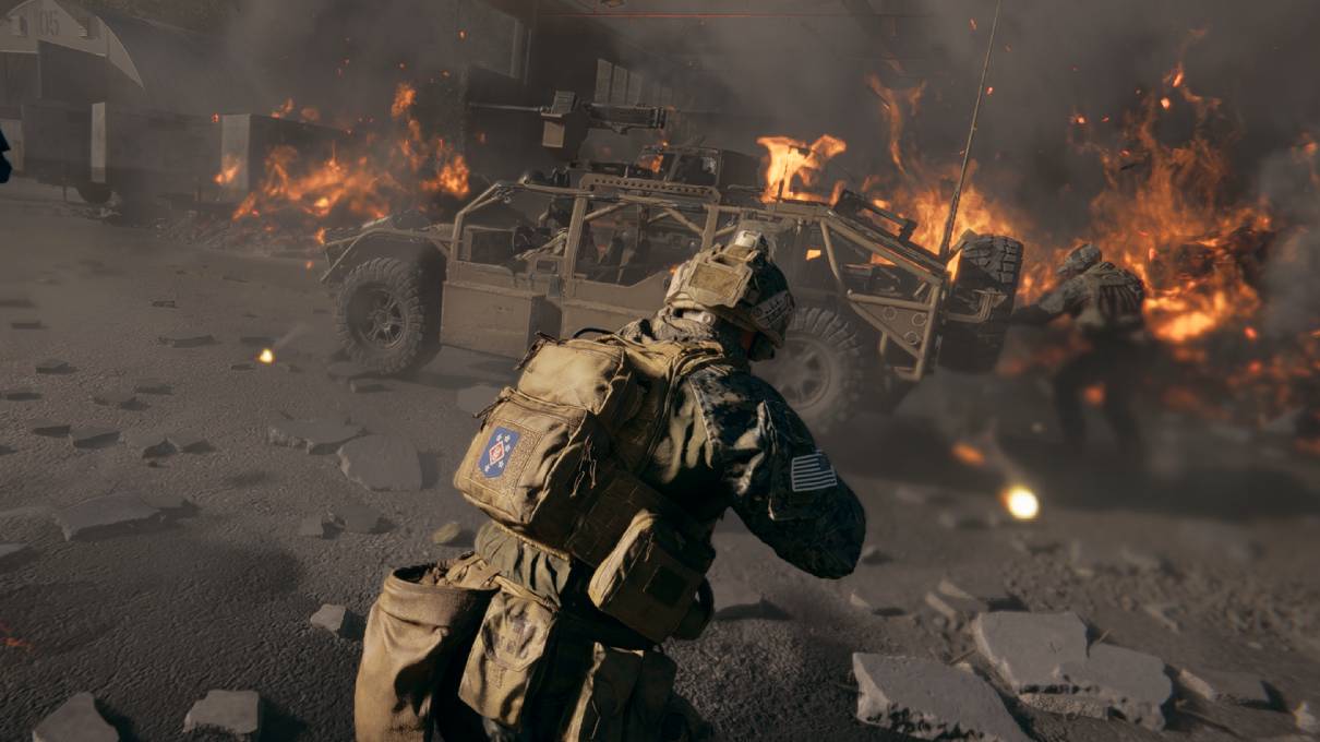A soldier in combat gear crouches on a debris-laden street, facing a burning military vehicle. Intense flames and smoke create a chaotic, war-torn atmosphere