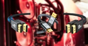 Three HDMI cables with varying connectors against a blurred background of computer hardware, including the best DisplayPort cable.