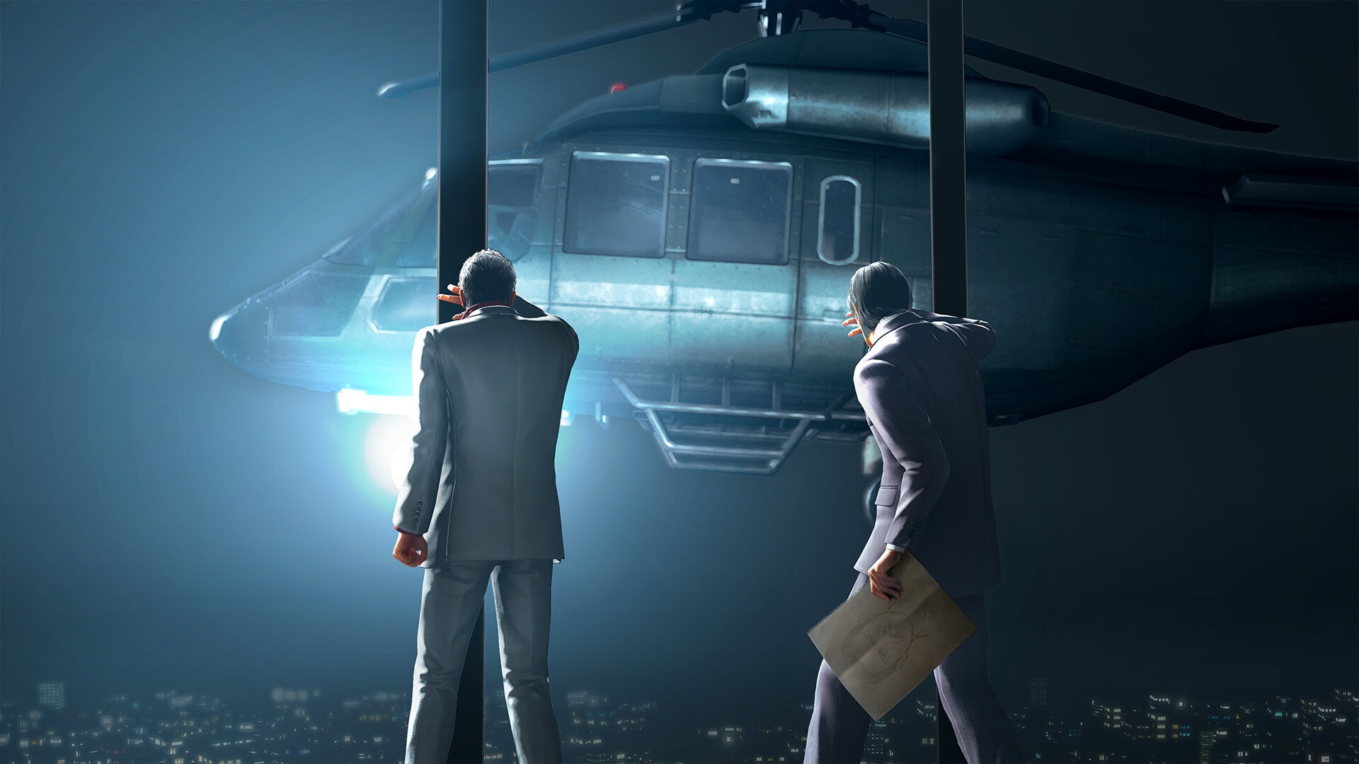 Two men in suits stand on a rooftop at night, facing a bright spotlight from an approaching helicopter in Yakuza Kiwami 3