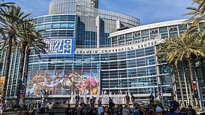 A large building with palm trees in front of it during Blizzcon 2023.