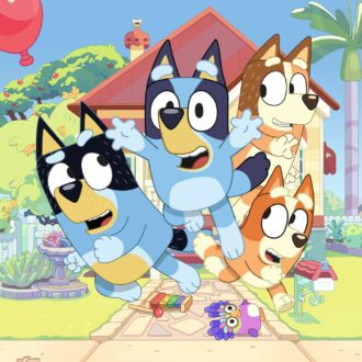 A group of cartoon dogs running in front of a house.