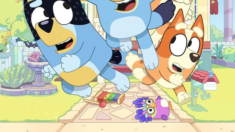 A group of cartoon dogs running in front of a house.