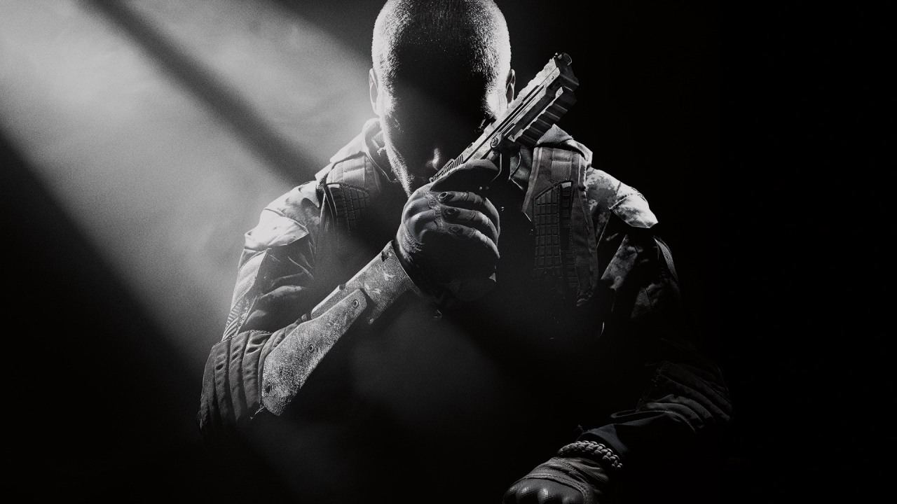 Black and white image of a person in Call of Duty tactical gear holding a rifle, backlit by dramatic lighting.