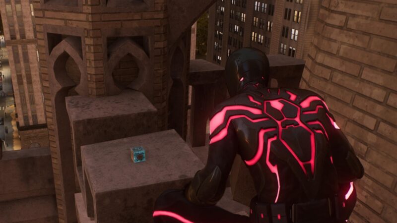 Spider-Man 2's Miles Morales in a red suit is standing on a rooftop at the location of the science trophy