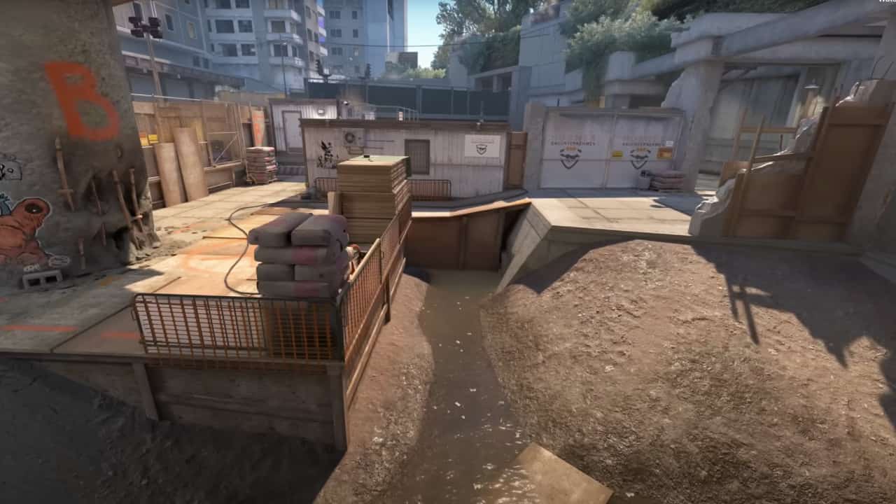 Counter Strike 2 release date: A wide, overhead angled shot of a muddy construction yard map.
