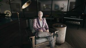 Dead Island 2 Curtis' Safe Key - Curtis Sinclair sitting on armchair in Emma Jaunt's mansion.