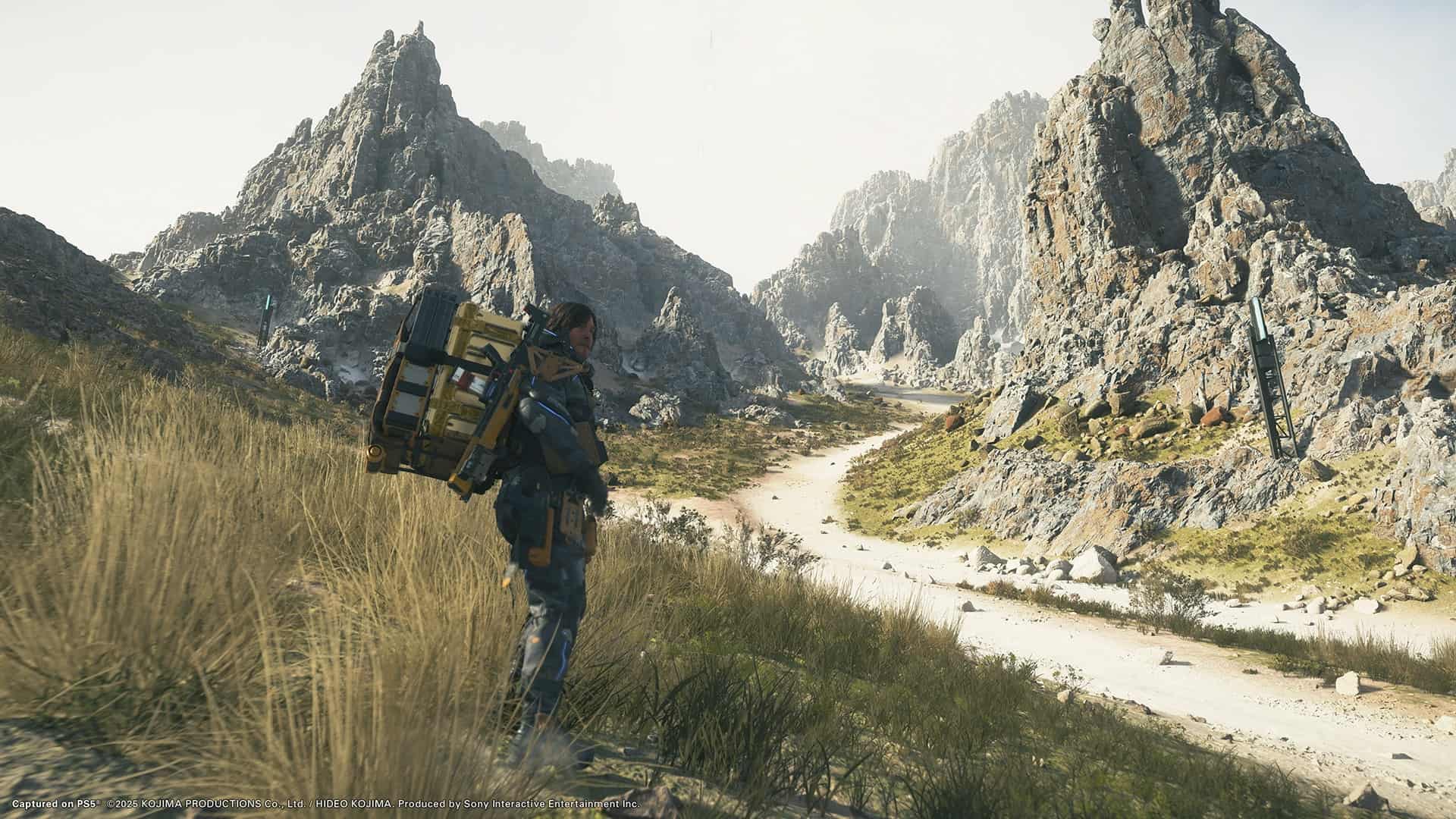 Sam Bridges exploring rocky terrain in Death Stranding 2 on PS5