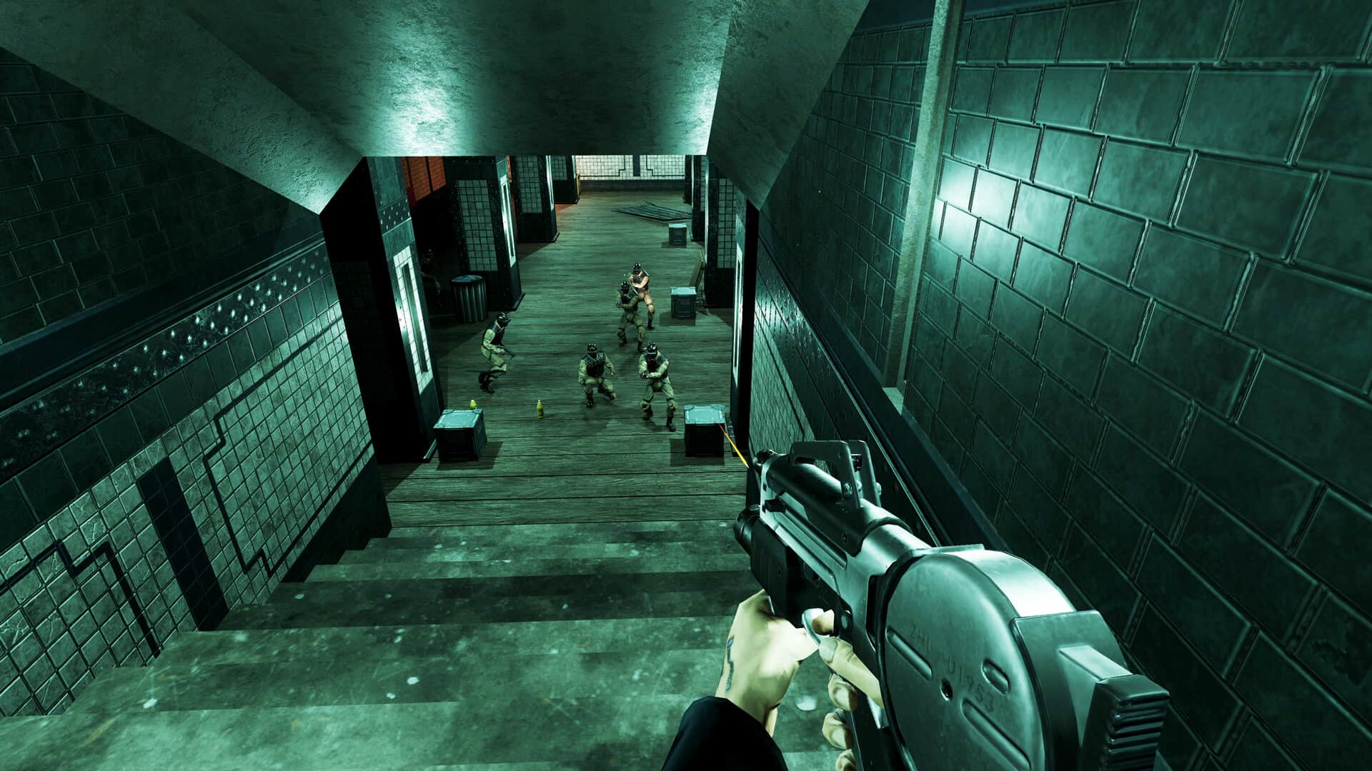 A first-person Deus Ex view shows a character holding a gun, aiming down a dark, tiled staircase