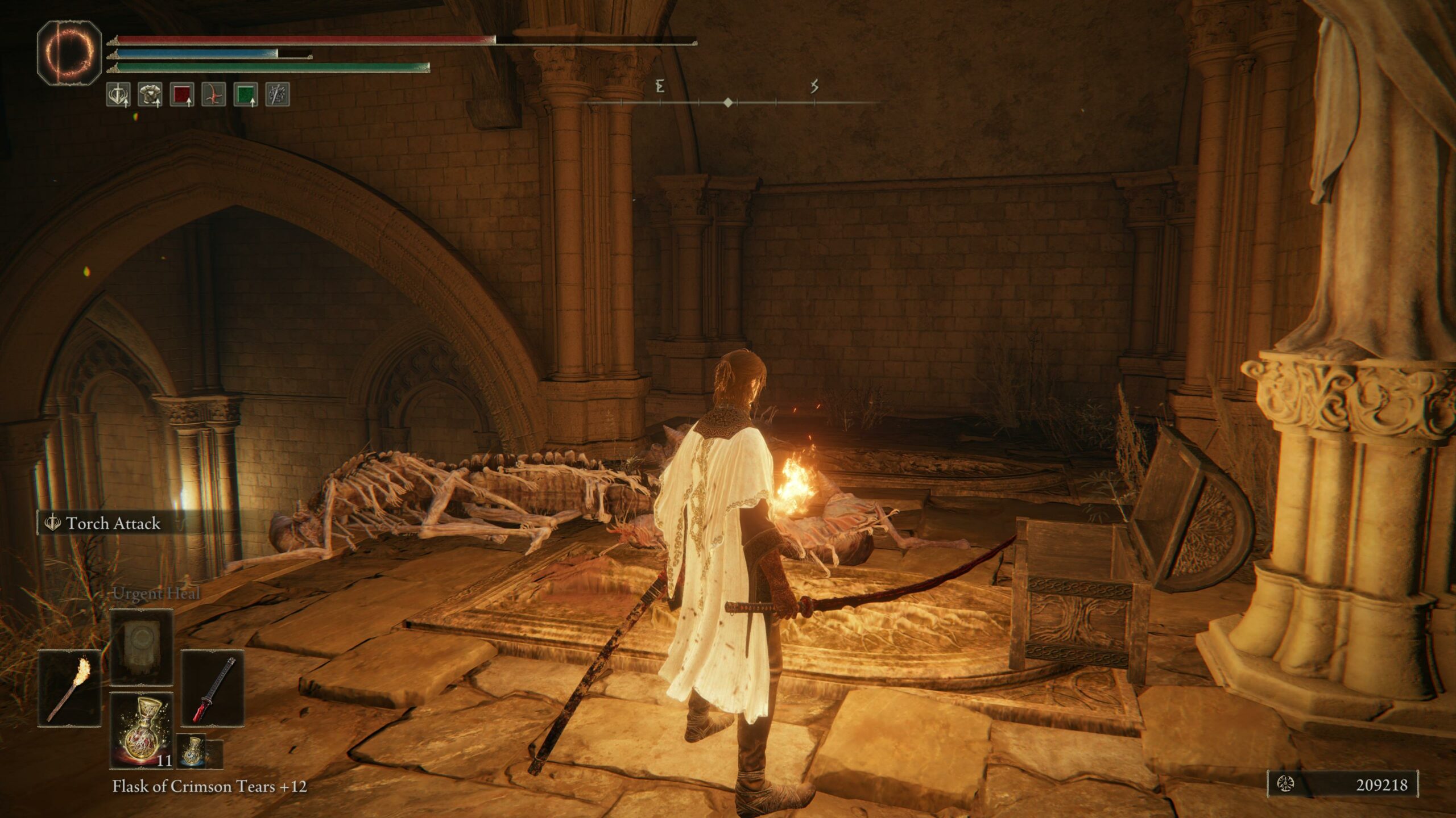 a woman holding a torch looks at an empty treasure chest