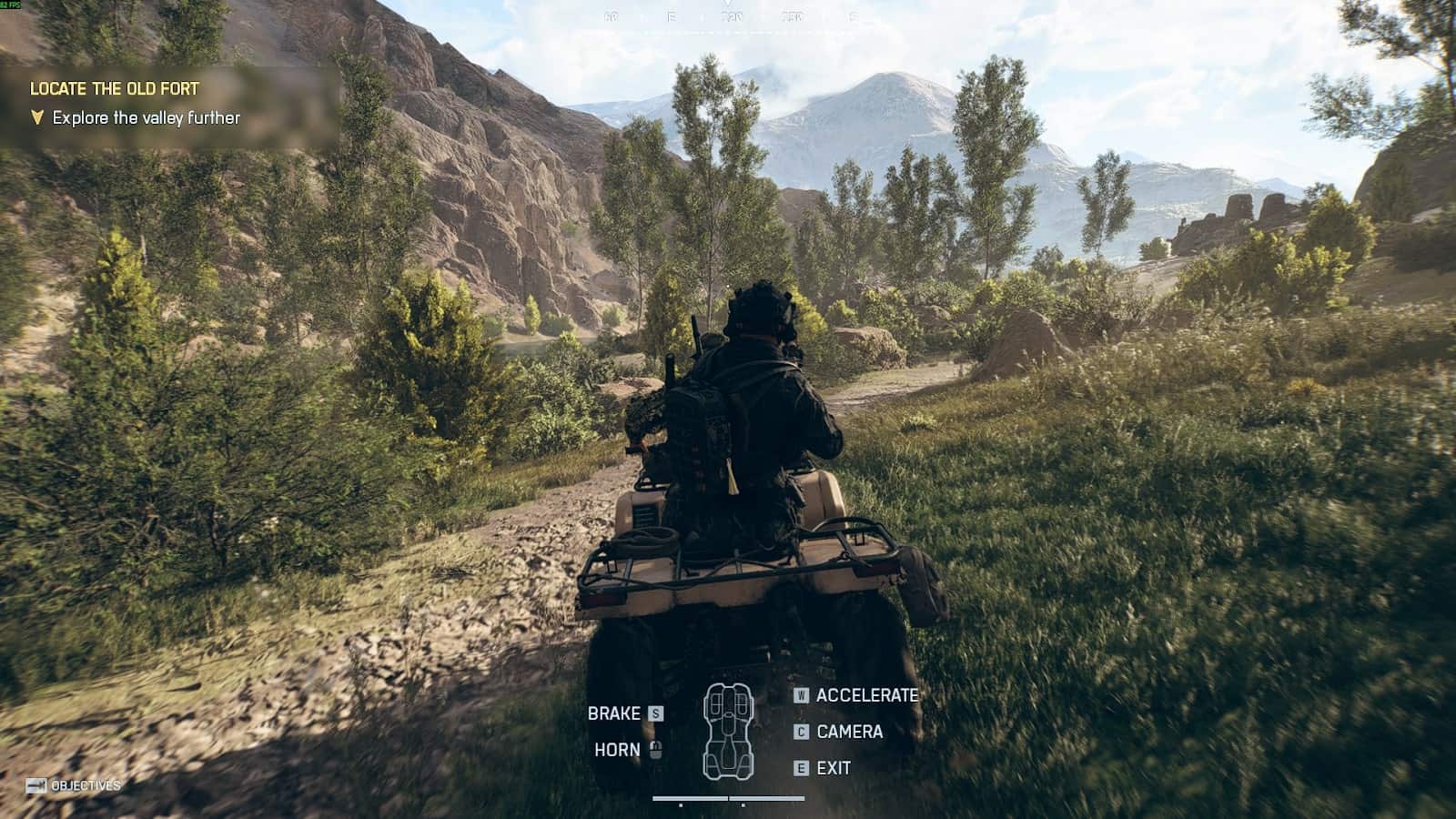 Soldier riding an ATV through a mountain valley during the “Locate the Old Fort” mission in Battlefield 6