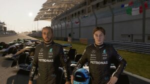 F1 24 best controller settings: Lewis Hamilton and George Russel standing in front of an F1 car on a track at sunset.