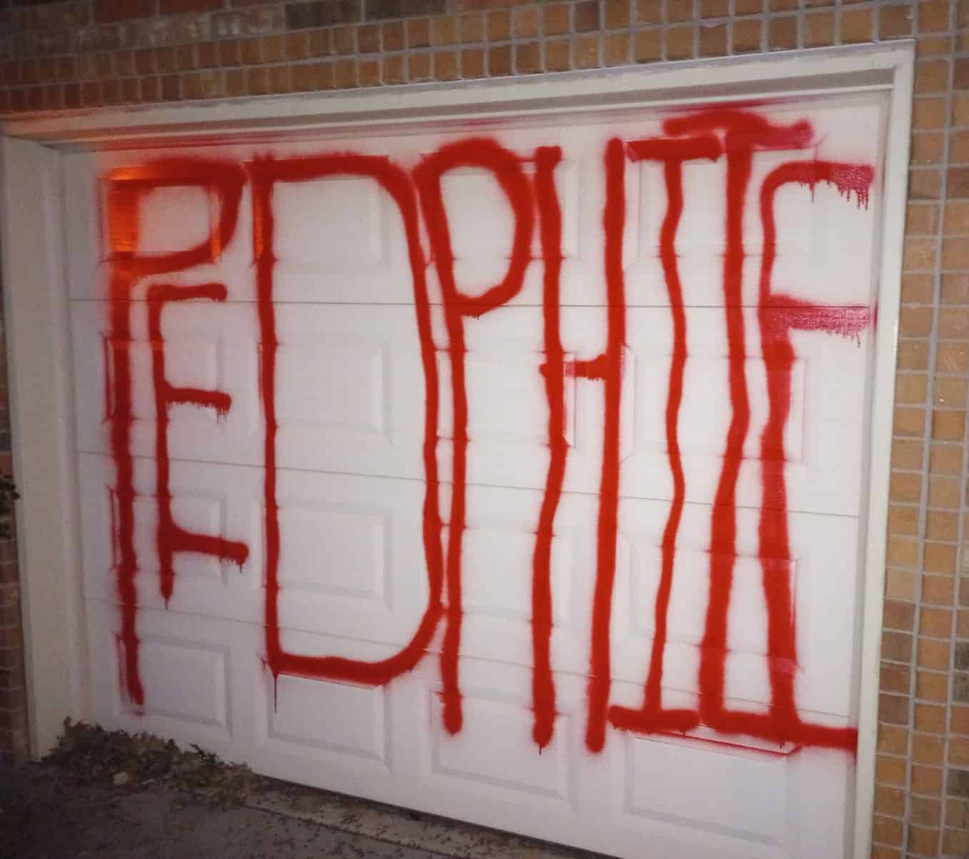 A garage door with the word "pephie" written on it was allegedly vandalized by a local Magic: the Gathering shaman at Boogie2988's house.