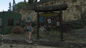 A woman is standing next to a sign at one of the wildlife photography locations in a video game.