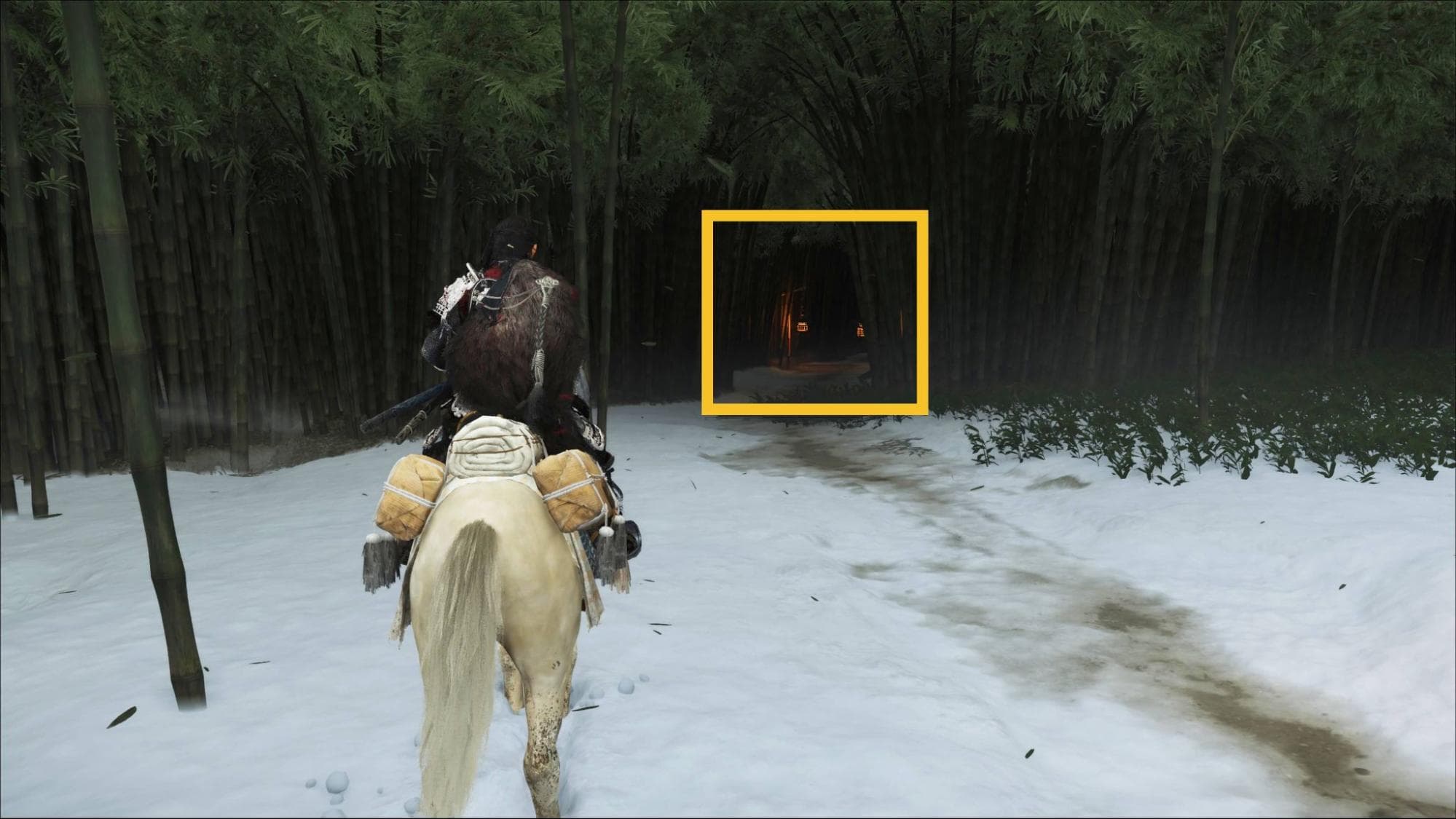 Ghost of Yotei character on horseback travels through a snow-covered bamboo forest