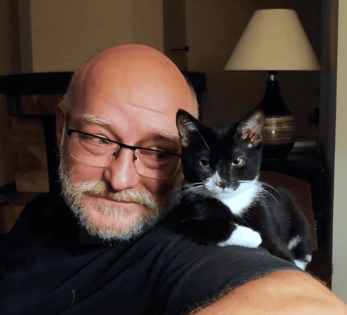 Producer Tadeusz Zuber along with his pet cat. Image provided by One More Level.
