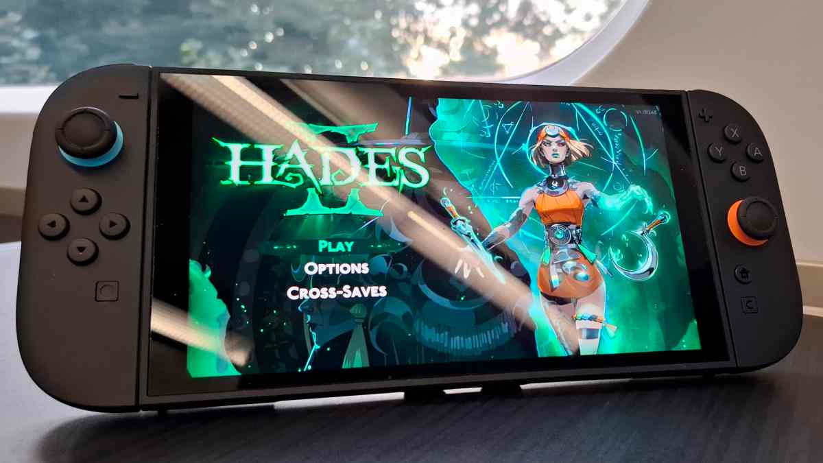 Nintendo Switch showing Hades 2 main menu with Melinoë, the protagonist, ready to play with options and cross-save features visible on screen.
