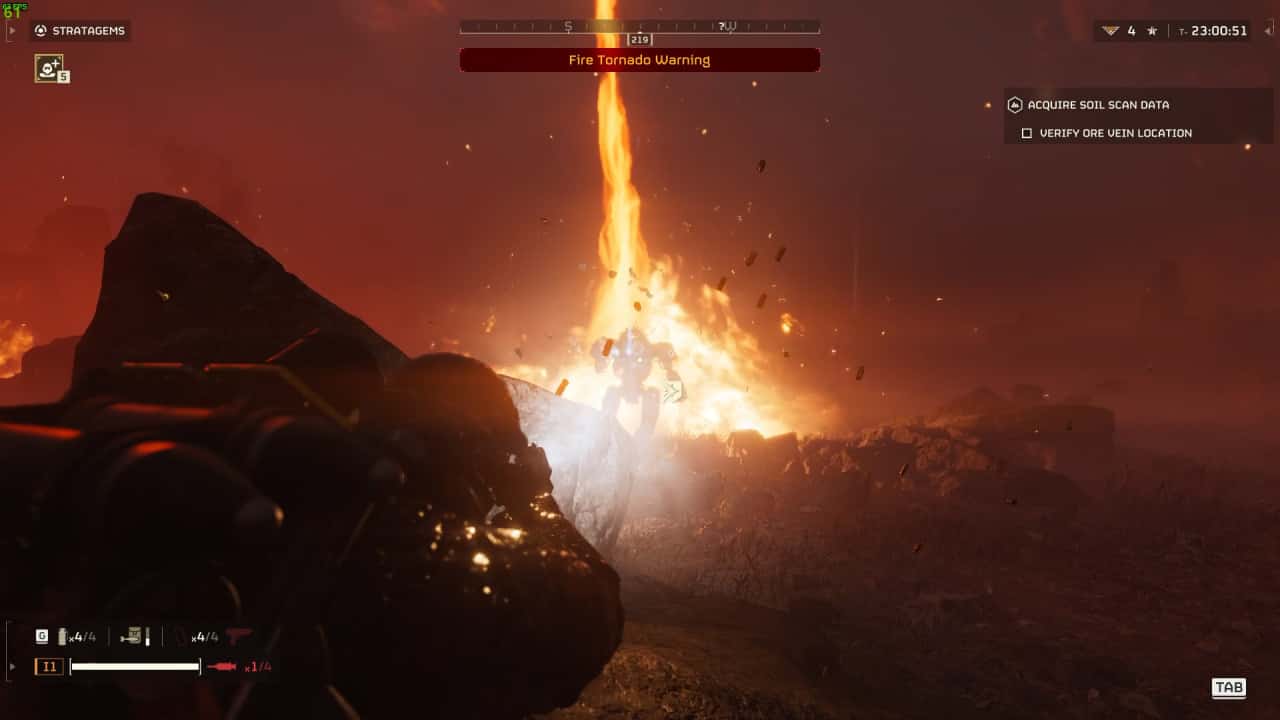 A Helldivers 2 video game screenshot showing a character witnessing a fiery tornado at night, with mission objectives displayed on the screen.