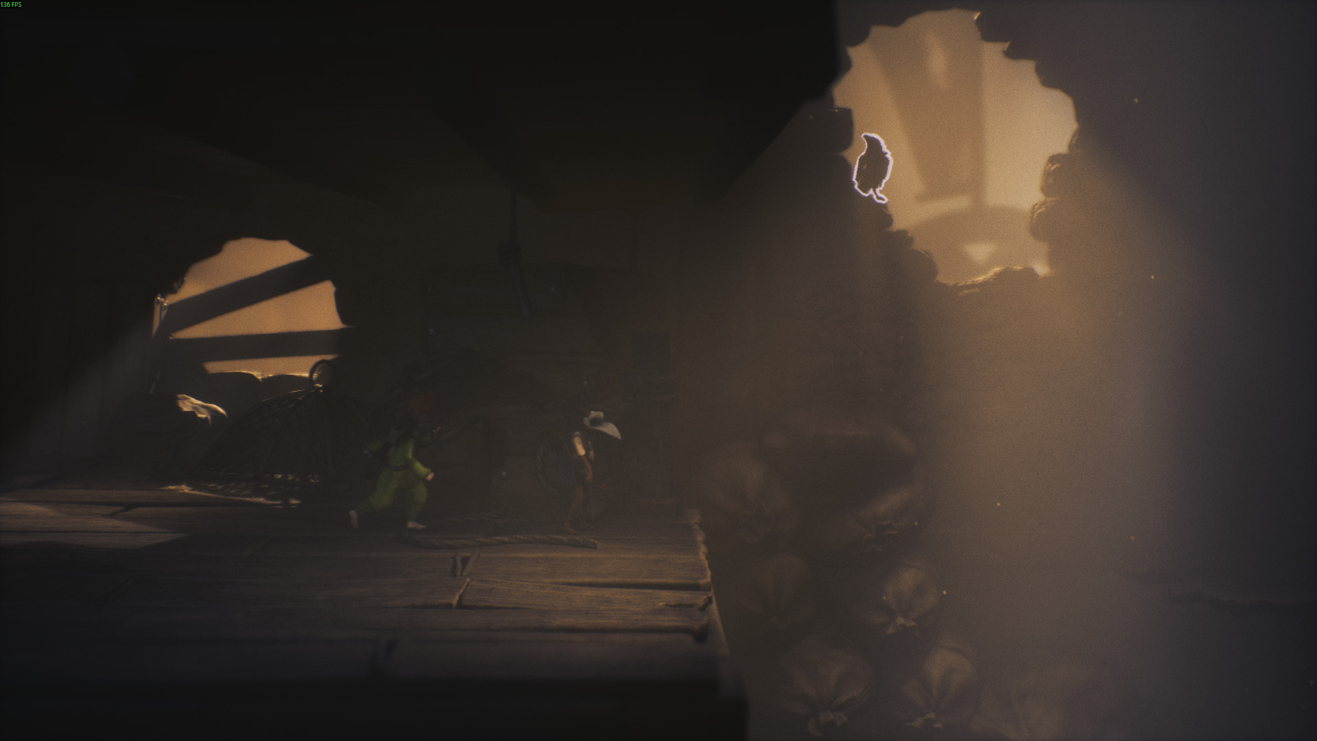 A glowing crow sits in a beam of light above sandbags in Little Nightmares 3 Chapter 1