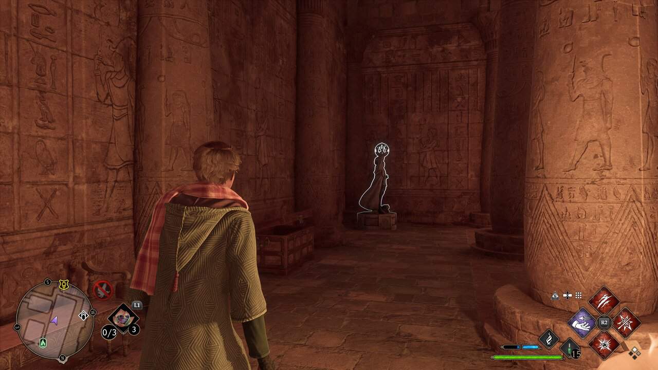 boy looking at statue in hogwarts legacy 