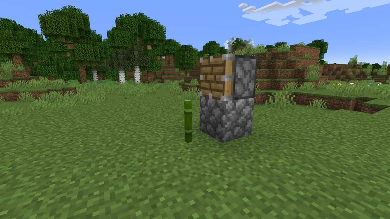 How to make a Minecraft bamboo farm: A cobblestone block with a piston block on top now sit to the right hand side of the growing bamboo shoot.