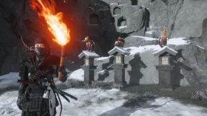 Warrior holding a burning torch beside fox lantern statues in the snowy Ghost of Yotei Snow Drift Springs Shrine area