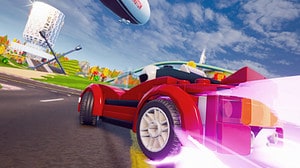 Is Lego 2K Drive free to play: A lego car drifts around a racetrack, purple streaks of light bursting from the back of the vehicle.