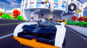 Is Lego 2K Drive on Game Pass: A lego car races forward through a chaotic race track.