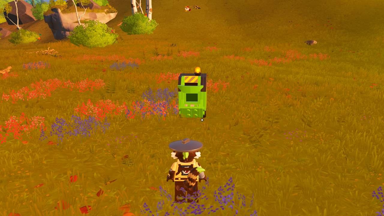 A character wearing a cowboy hat observing a green, multi-level compost bin in a vibrant, colorful meadow in LEGO Fortnite.