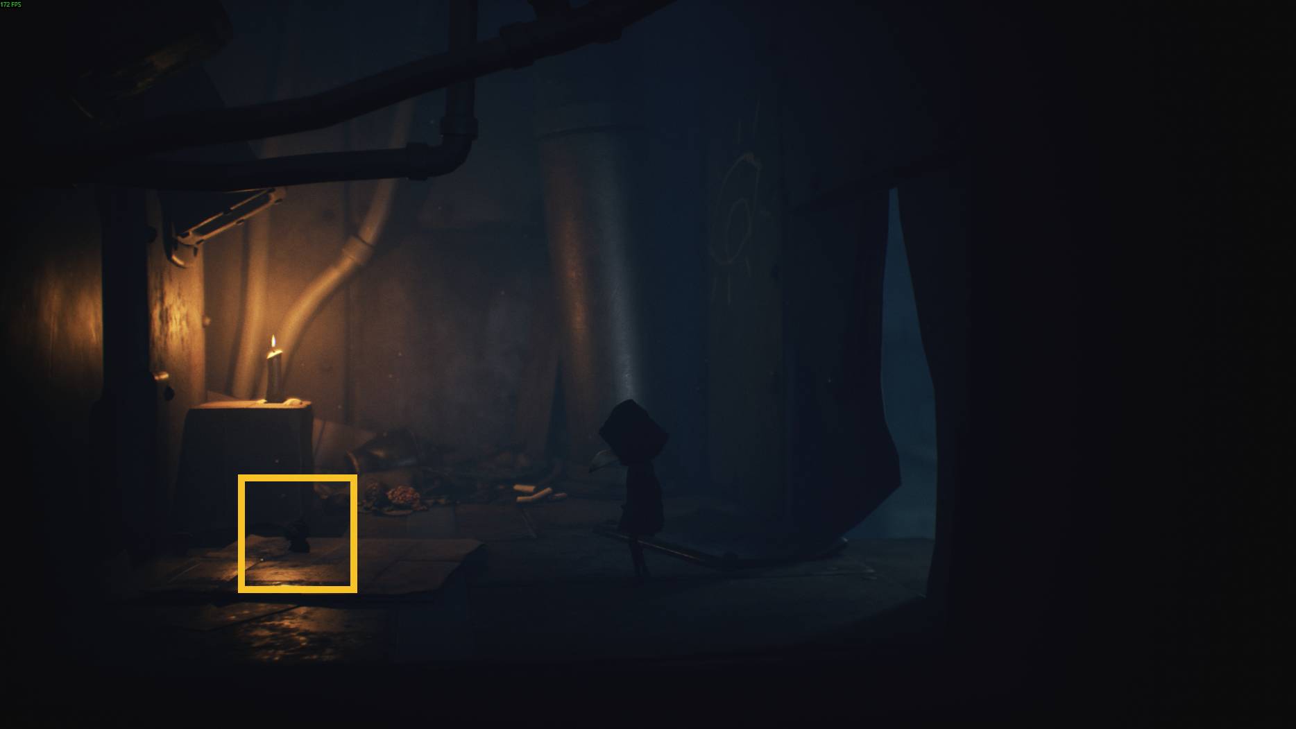 Little Nightmares 3 screenshot of a dark room with pipes and a lit candle on a box, a small hidden doll figure on the floor