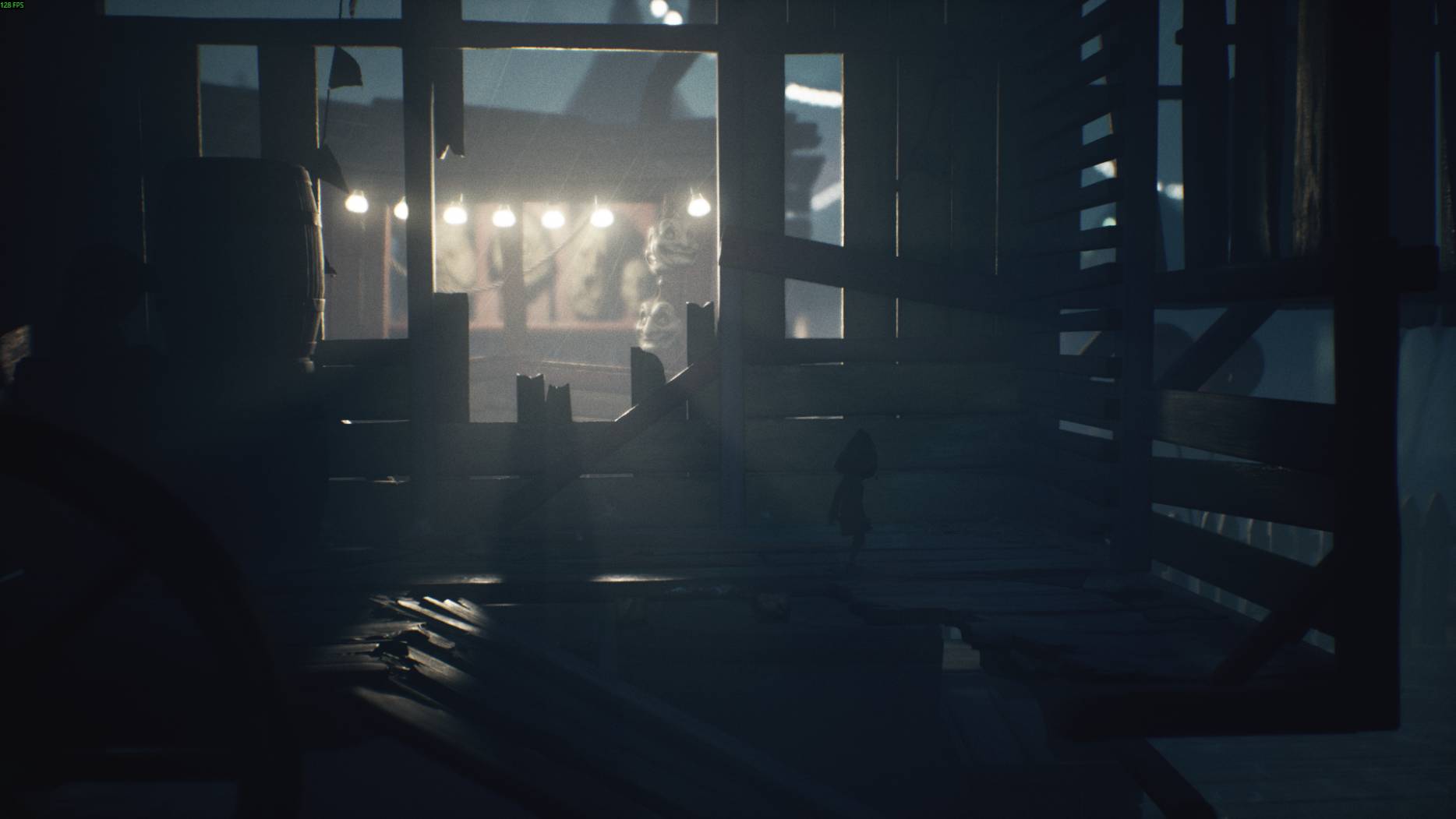 A dark wooden shack with carnival masks glowing through the window as a small character walks inside in Little Nightmares 3.