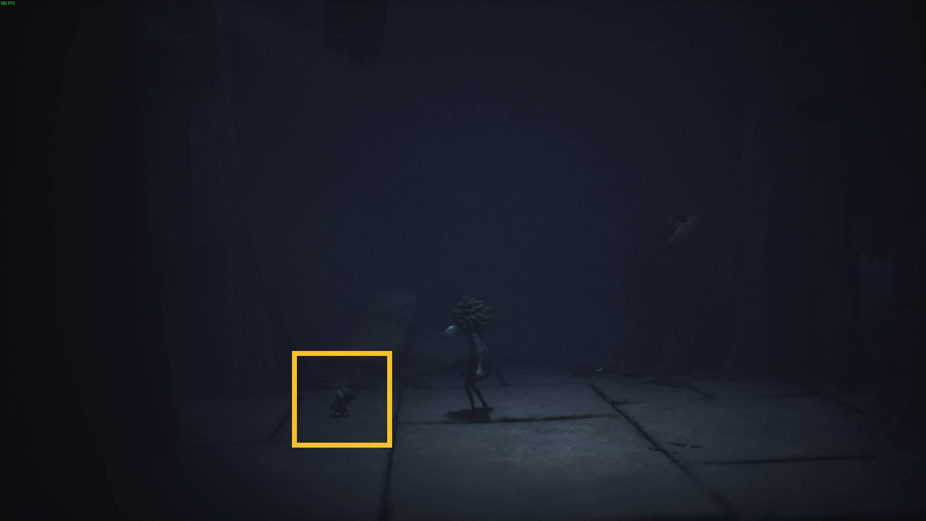 A small character walks through a shadowy hallway in Little Nightmares 3, with a tiny doll-like figure crouching nearby