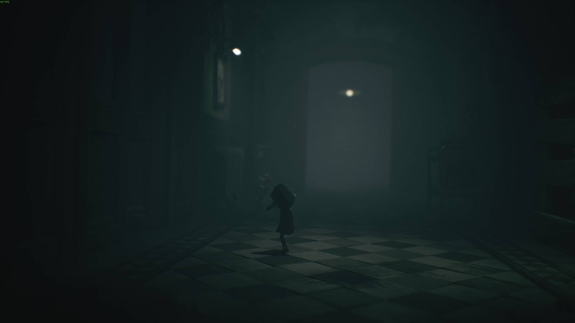 A character walks through a dark hallway with checkered floor tiles in Little Nightmares 3